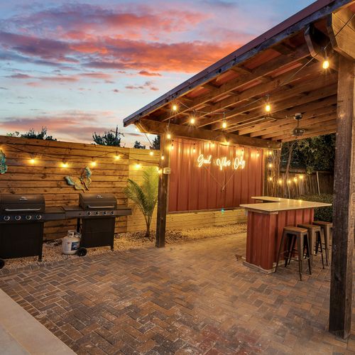 Gather under the string lights for a cookout or cocktails at the ‘Good Vibes Only’ bar—perfect for celebrating New Orleans style in a relaxed and inviting setting.