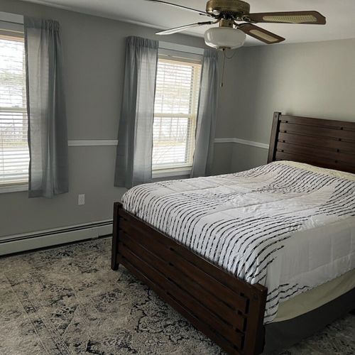 Bedroom #1 (main floor):  features a queen-size bed, dresser, nightstand, mirror, closet, ceiling fan, and a very nice lake view!