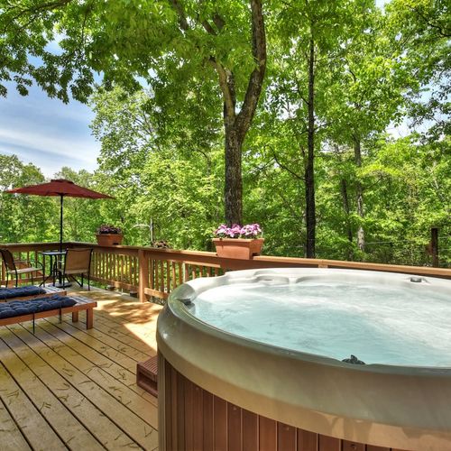 Soak and relax in the hot tub while enjoying the picturesque view.
