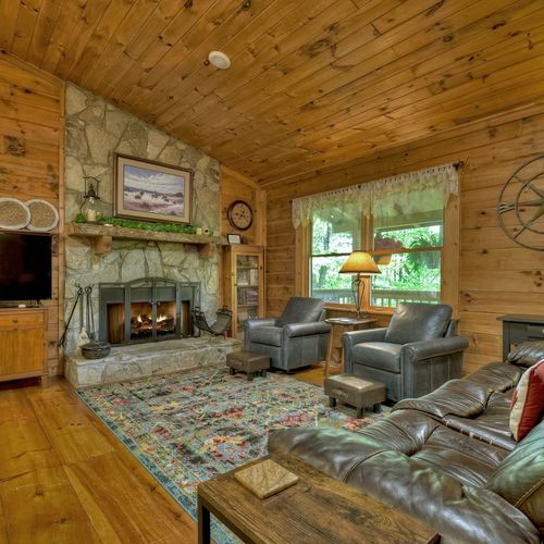 Relax in an inviting living space with plush seating and a widescreen TV, designed for your relaxation and enjoyment.