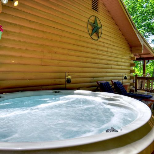 Soak and relax in the hot tub while enjoying the picturesque view.