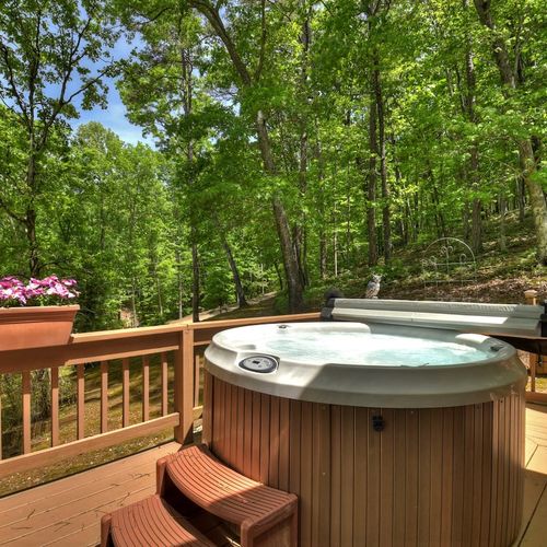 Soak and relax in the hot tub while enjoying the picturesque view.