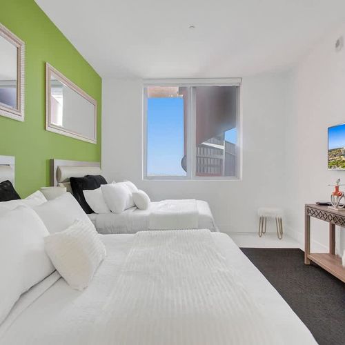 Bedroom 2 features two full-size beds and a private TV, making it perfect for children or guests on a family vacation.
