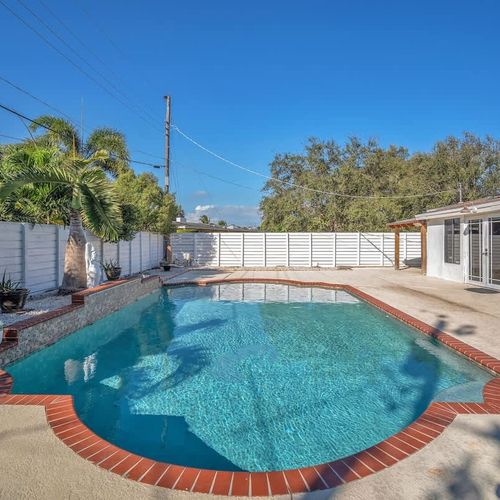 Savor the Pompano Beach sunshine as you unwind in this charming private pool, safely enclosed by a fence to protect your privacy.