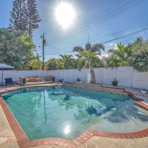 Savor the Pompano Beach sunshine as you unwind in this charming private pool, safely enclosed by a fence to protect your privacy.