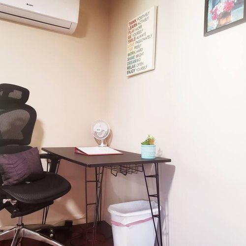 A comfortable and functional workspace featuring a sleek desk, ergonomic chair, and a calming decor, perfect for remote work or study.