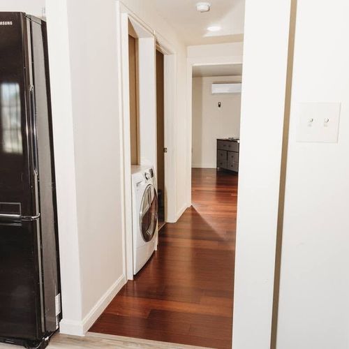 Hallway leading to laundry and rooms.