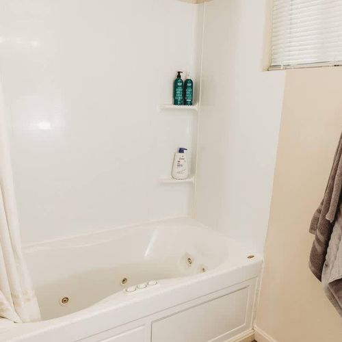 Relaxing bathtub with built-in shelving for essentials.