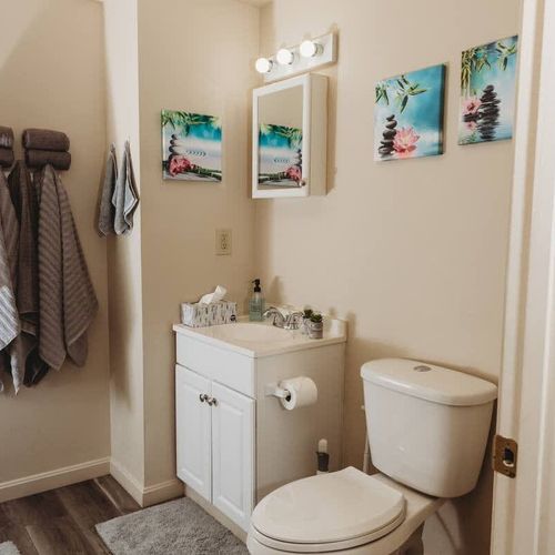 Well-lit vanity area with a mirror and storage space.