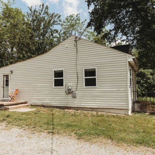 Back view of the home – A quiet and private space with ample parking and peaceful surroundings.