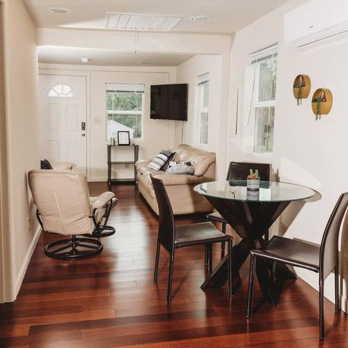 Bright open living and dining area with cozy seating and modern decor.