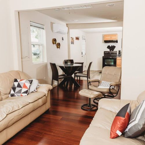 Cozy living space with stylish decor, comfy seating, and an open kitchen.