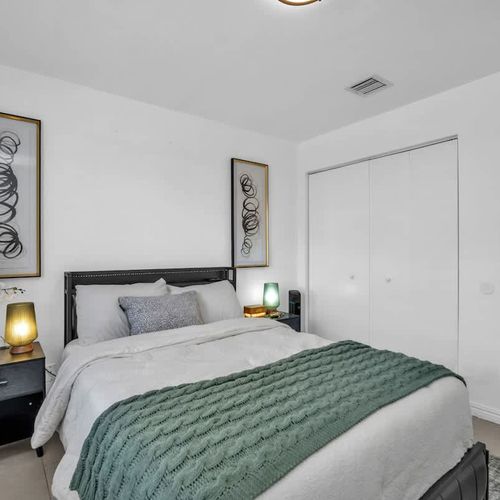 The unit features spacious bedrooms, each furnished with plush beds, crisp linens, and a private TV for ultimate comfort.
