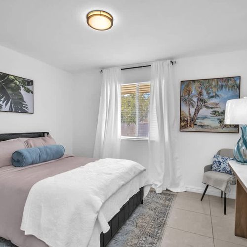 The unit features spacious bedrooms, each furnished with plush beds, crisp linens, and a private TV for ultimate comfort.
