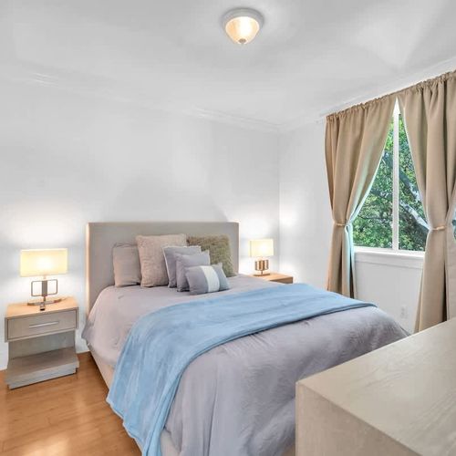 Cozy and inviting bedroom Bedroom 3 with soft lighting, a plush bed, and a window view of lush greenery—perfect for a restful stay.