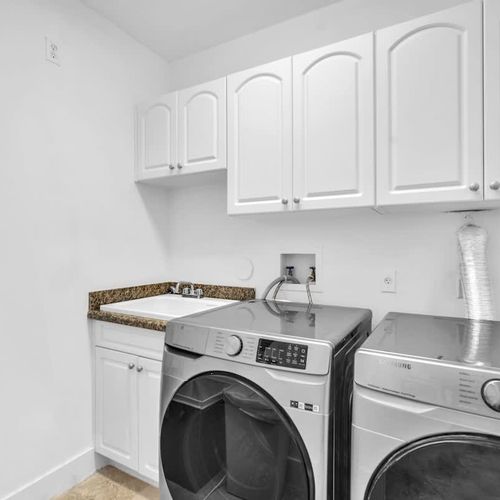Convenient laundry room with modern washer, dryer, and ample storage. Enjoy the ease of fresh, clean clothes during your stay.