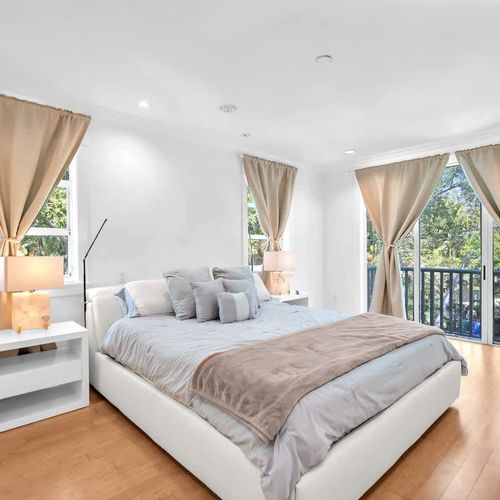 Relax in this serene, modern bedroom 1 designed for comfort. Enjoy a plush bed, elegant décor, and sunlit windows. Step onto the private balcony for peaceful views—your perfect retreat awaits!