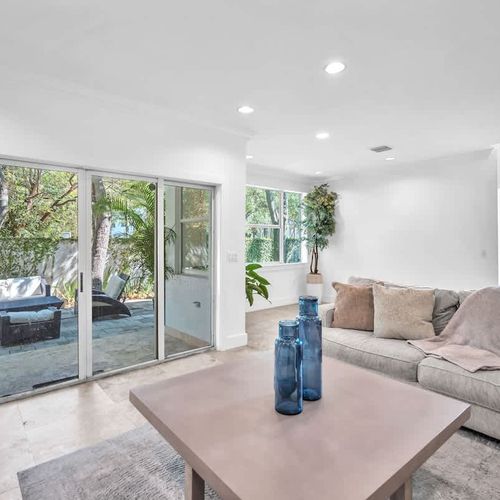 Relax in a bright living space that opens to a lush outdoor patio—perfect for lounging and enjoying nature.