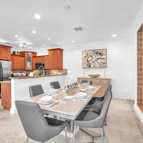 Dine in style with a sleek table, modern seating, and an open flow to the kitchen.
