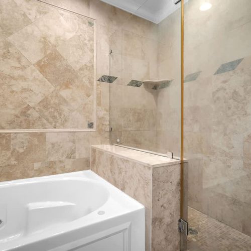 Relax in style with a spacious walk-in shower and a luxurious soaking tub.