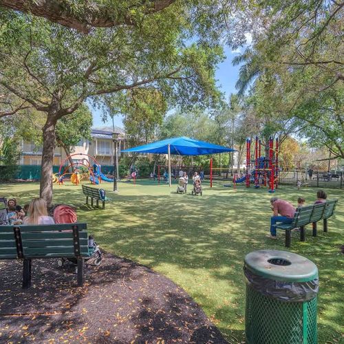 Nearby shaded playground with benches—great for families to unwind while kids have fun.
