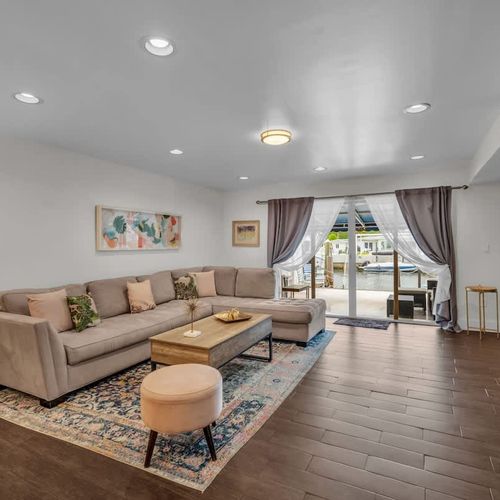 Comfy living room for relaxing or watching TV, with easy access to the patio and peaceful dockside views just steps away.