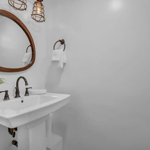 The sleek pedestal sink offers a stylish, inviting spot for a quick refresh or wind-down.