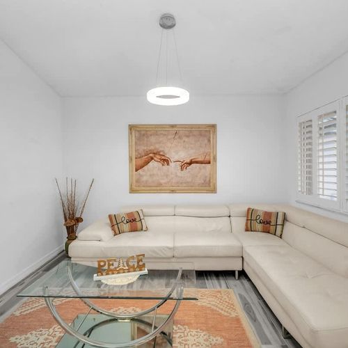 A bright and airy living space featuring stylish decor and a cozy, inviting couch.