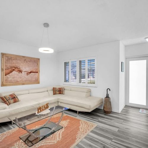 A bright and airy living space featuring stylish decor and a cozy, inviting couch.