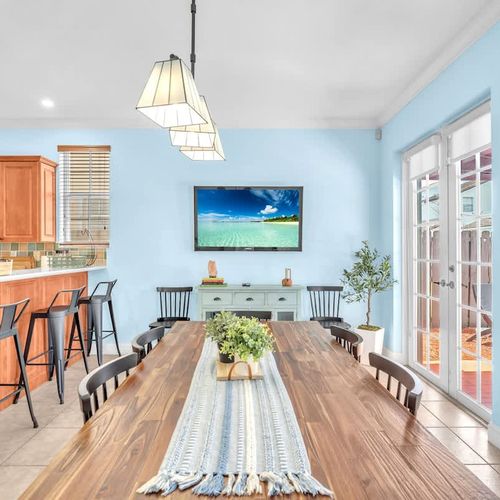 The bright and spacious dining area seats up to 8 guests and offers a lovely view of the pool