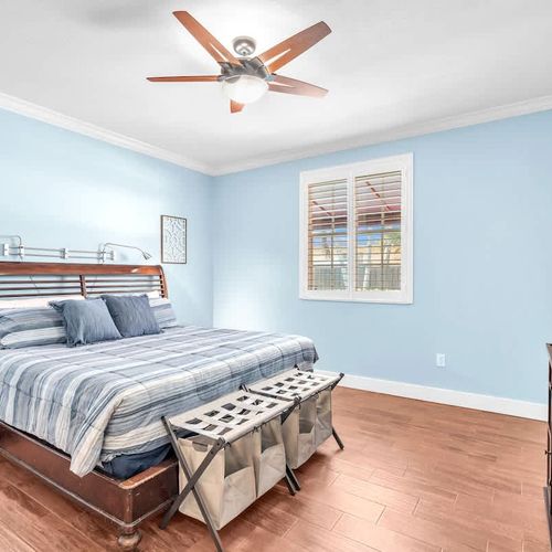 Spacious and serene first bedroom, complete with its own en suite bathroom and a TV for your entertainment.