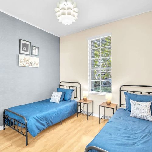 Bedroom 4 features two comfortable single beds, perfect for guests traveling with children.