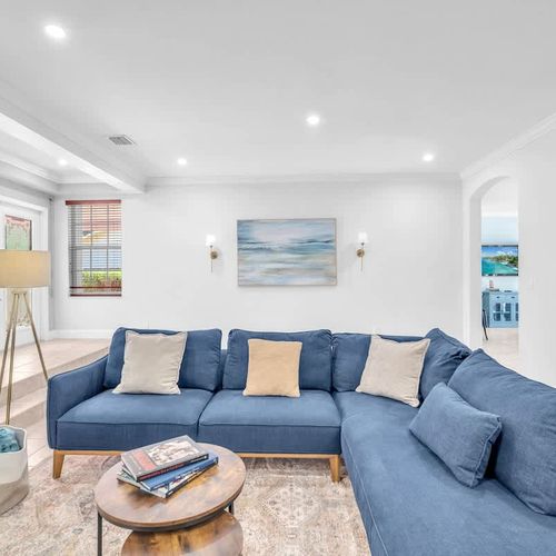 Bright and airy living space with a large L-shaped sofa, an ideal place for relaxing and gathering for movie nights.
