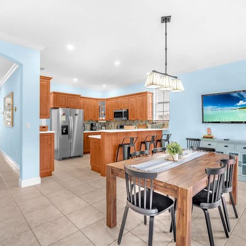The bright and spacious dining area seats up to 8 guests and offers a lovely view of the pool