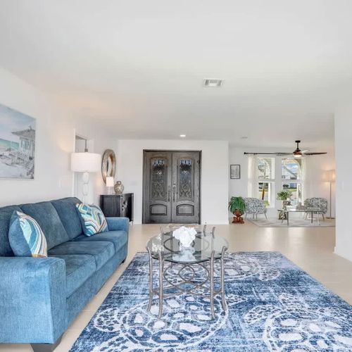 Settle into the cozy living area for a movie night—complete with a scenic lake backdrop.