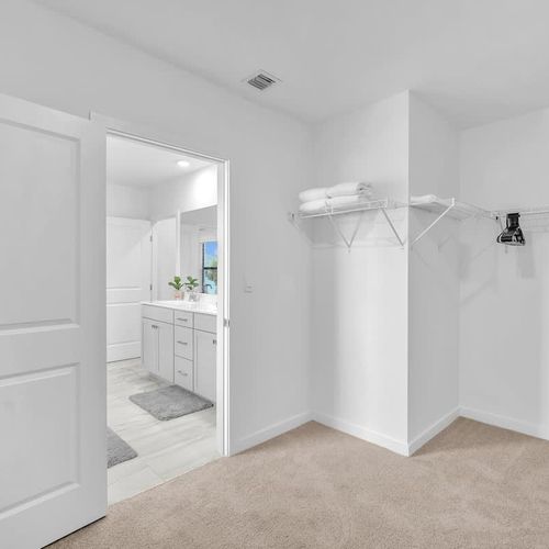 In addition to its amenities, the full bathroom for the first bedroom offers a generous walk-in storage space with fresh linens and hangers for neatly storing your clothes.