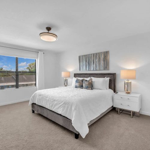Bedroom 1 offers plenty of space, with a cozy queen-sized bed, a large-screen TV, a private ensuite bathroom, and a generous closet.
