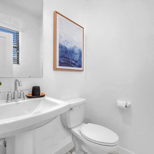 Bathroom 1 features a generous bathtub, a separate walk-in shower, and a spacious vanity for added convenience.