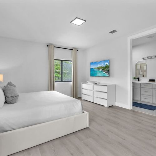 Bedroom 1 offers a comfy king-sized bed, a spacious closet, a versatile dressing table that doubles as a work desk, and the convenience of a private ensuite bathroom.