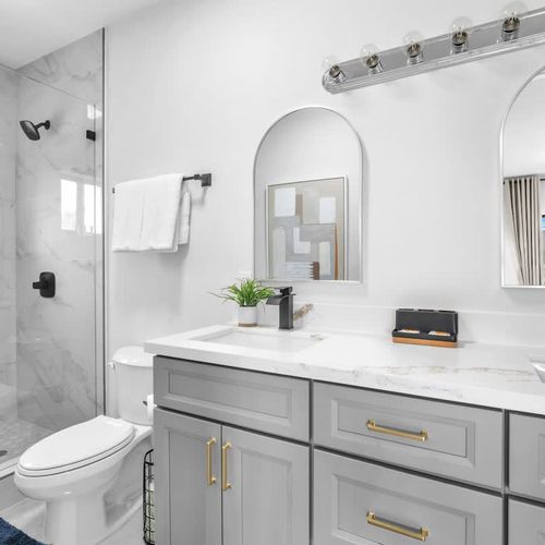 The ensuite bathroom in Bedroom 1 features a his-and-hers vanity, generous storage space, and all the essentials for a comfortable and convenient stay.