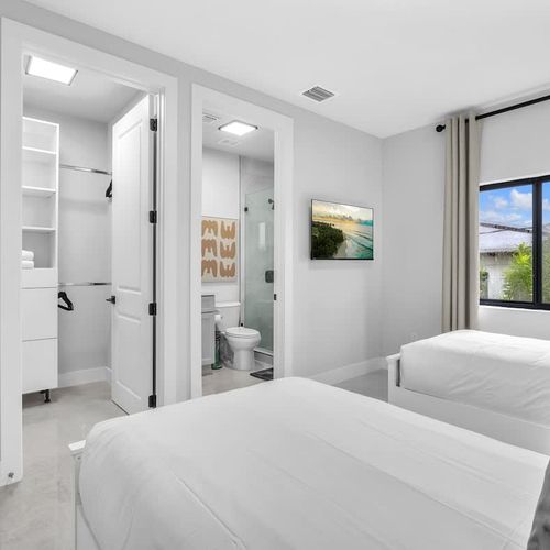 Bedroom 4 is perfect for families with kids, featuring two comfy single beds, a private TV, spacious closets, and its own ensuite bathroom for added convenience.