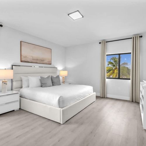 Bedroom 1 offers a comfy king-sized bed, a spacious closet, a versatile dressing table that doubles as a work desk, and the convenience of a private ensuite bathroom.