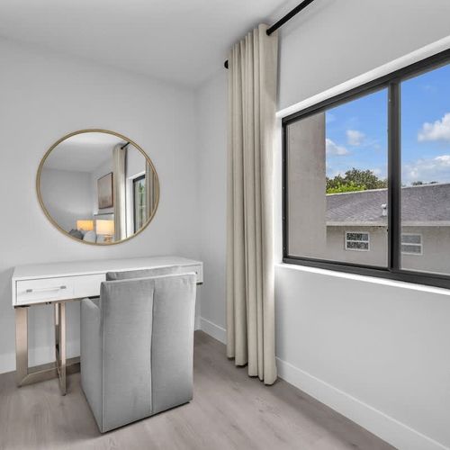 Bedroom 1 offers a comfy king-sized bed, a spacious closet, a versatile dressing table that doubles as a work desk, and the convenience of a private ensuite bathroom.