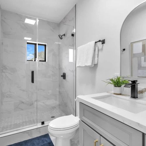 The ensuite bathroom in Bedroom 1 features a his-and-hers vanity, generous storage space, and all the essentials for a comfortable and convenient stay.