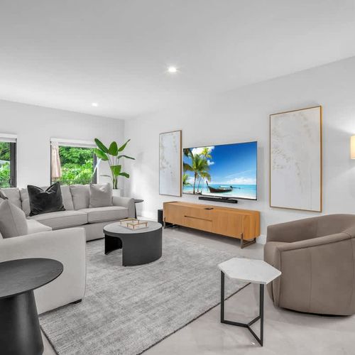 The spacious living room features a cozy sofa that converts into a pull-out bed and a widescreen TV so you can relax and enjoy your favorite shows in comfort.