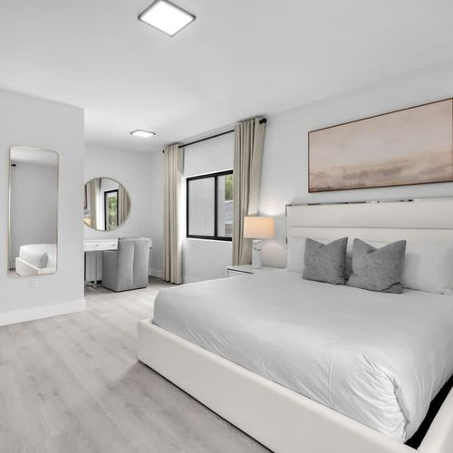 Bedroom 1 offers a comfy king-sized bed, a spacious closet, a versatile dressing table that doubles as a work desk, and the convenience of a private ensuite bathroom.