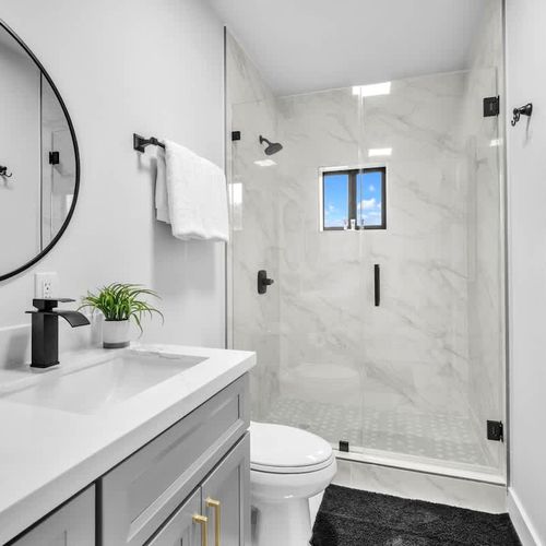 The ensuite bathroom in Bedroom 1 features a his-and-hers vanity, generous storage space, and all the essentials for a comfortable and convenient stay.