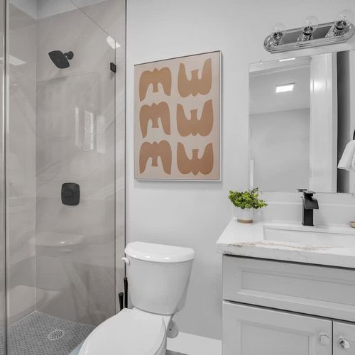 Bedroom 4’s ensuite bathroom is bright, clean, and comes with all the basics for your stay.