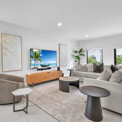 Spacious living room with a sofa bed and widescreen TV for relaxing and entertainment after a day of exploring.