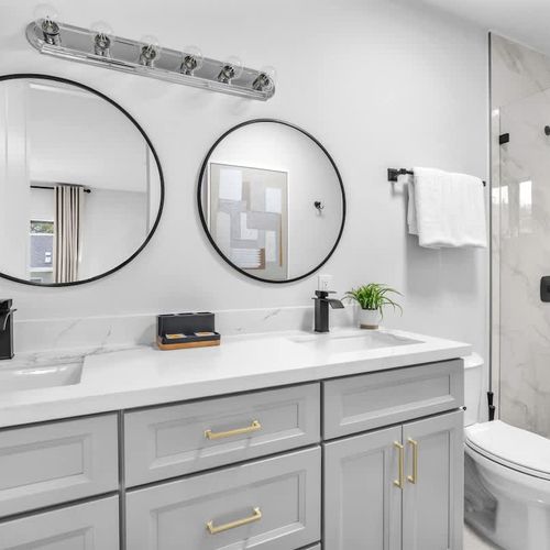 The ensuite bathroom in Bedroom 1 features a his-and-hers vanity, generous storage space, and all the essentials for a comfortable and convenient stay.